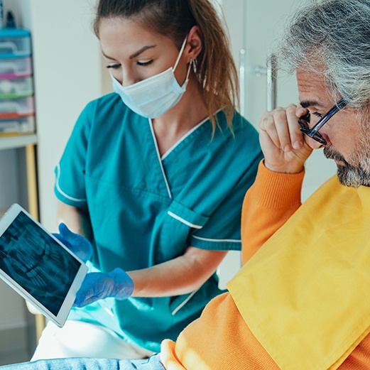 Dentist talking to senior man about All-on-4