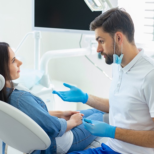 Patient talking to Schoharie dentist about tooth extraction 