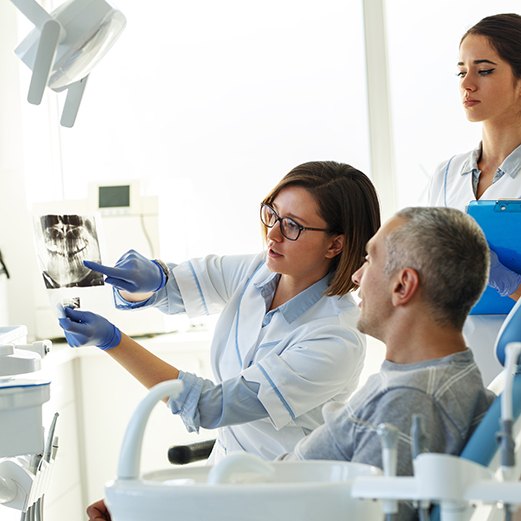 Schoharie dentist explaining extraction to patient 