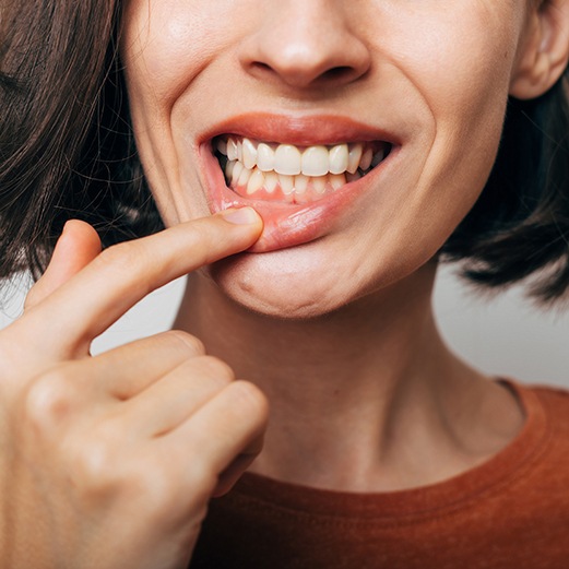 Woman looking closely at her gums 