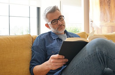 Man reading on couch