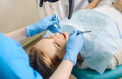 Dentist examining a patient’s mouth 