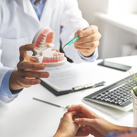 Dentist talking to patient about dental implant salvage 