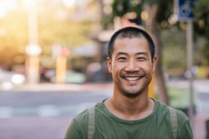 young man smiling outdoors 